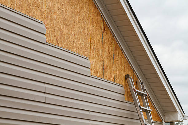 Professional Storm Damage Siding Repair technician working in Perryopolis, PA